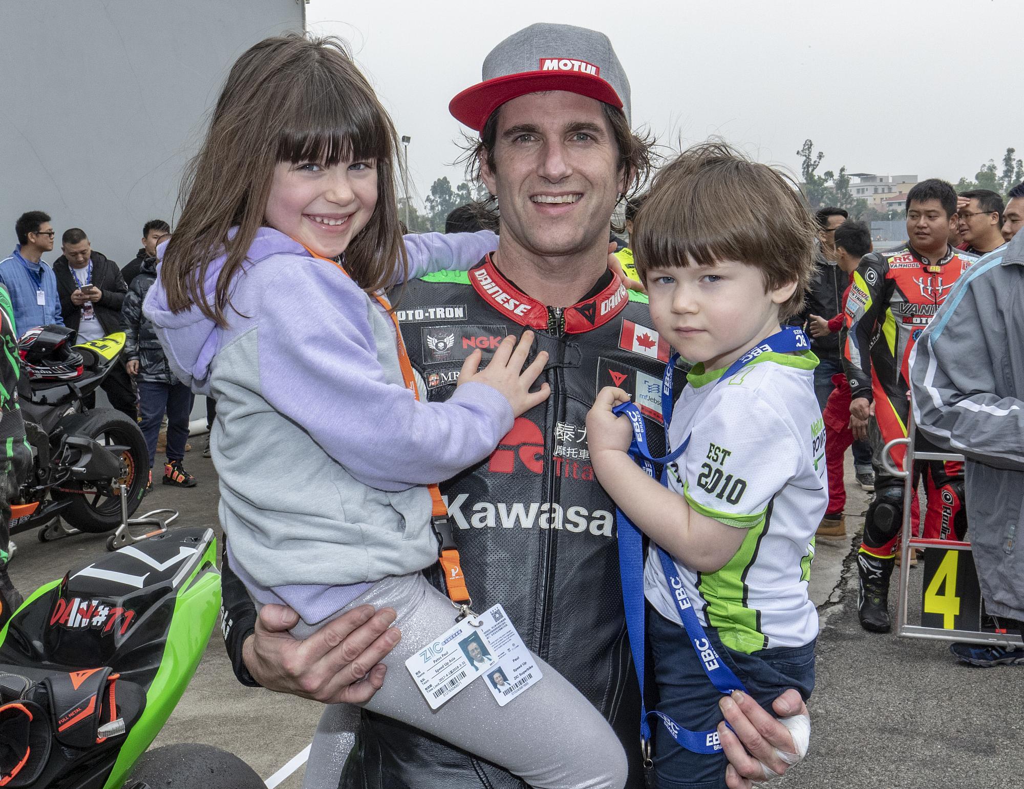 Man holding two young children