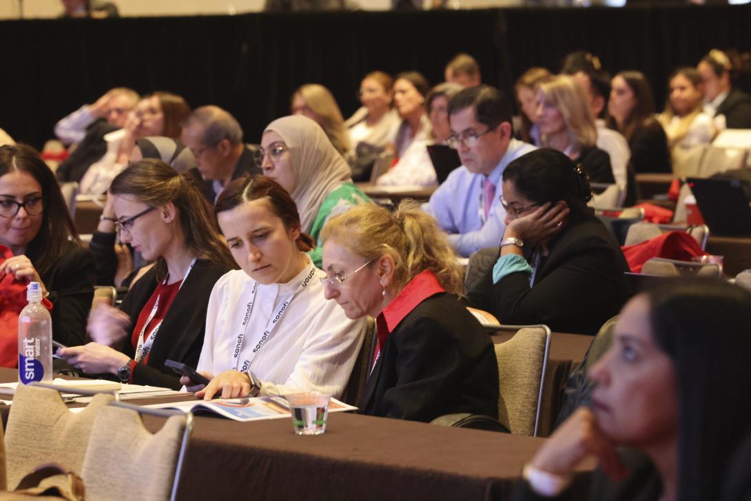 large room full of people listening to a presentation